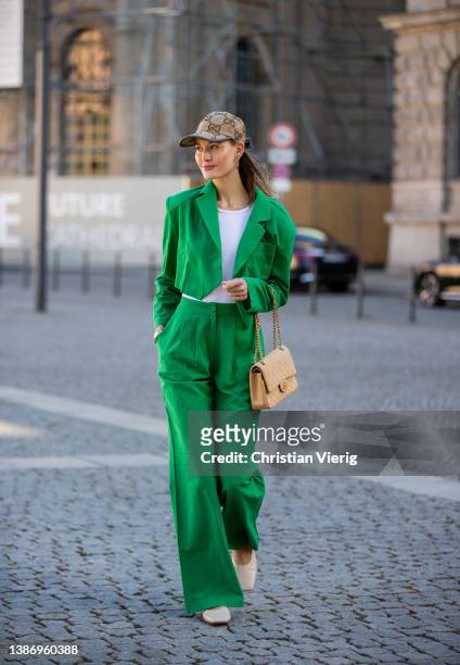 Mandy Bork is seen wearing green cropped Blazer & pants Storets, shoes María Luca, beige Chanel bag, cap Gucci on March 17, 2022 in Berlin, Germany.