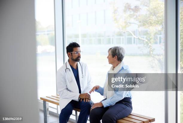 doctor in conversation with patient - cancer prevention stock pictures, royalty-free photos & images