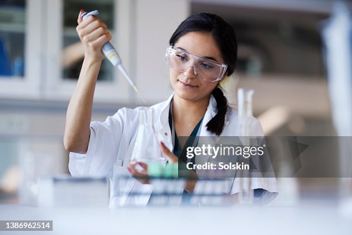 Young female scientist working in laboratory Young female scientist working in laboratory