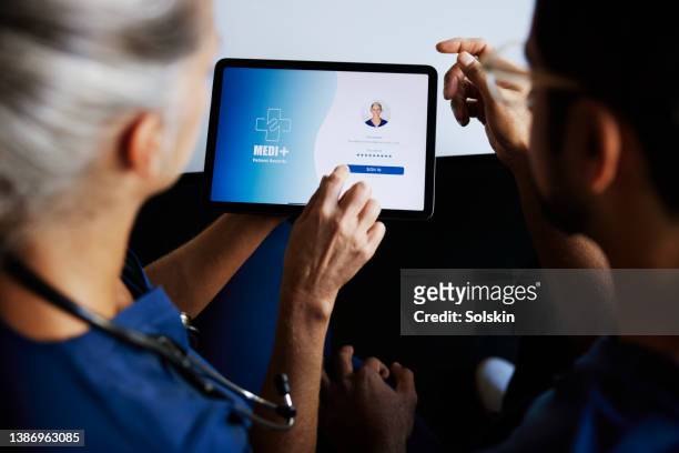 two doctors using digital tablet for medical records - choicepix stock pictures, royalty-free photos & images