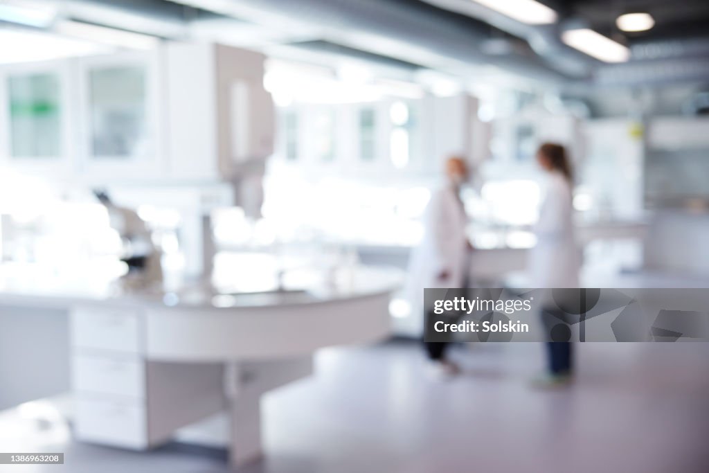 Defocused image of laboratory with two scientist