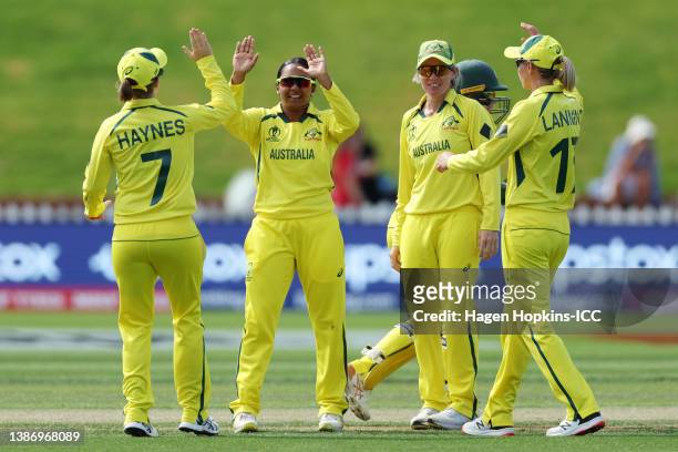Alana King of Australia celebrates with teammates after dismissing Lizelle Lee of South Africa during the 2022 ICC Women's Cricket World Cup match...