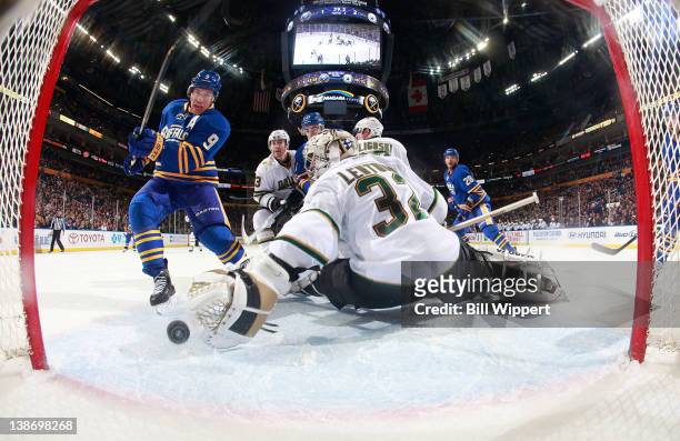 Derek Roy of the Buffalo Sabres scores the game tying goal late in the third periodl against Kari Lehtonen of the Dallas Stars at First Niagara...