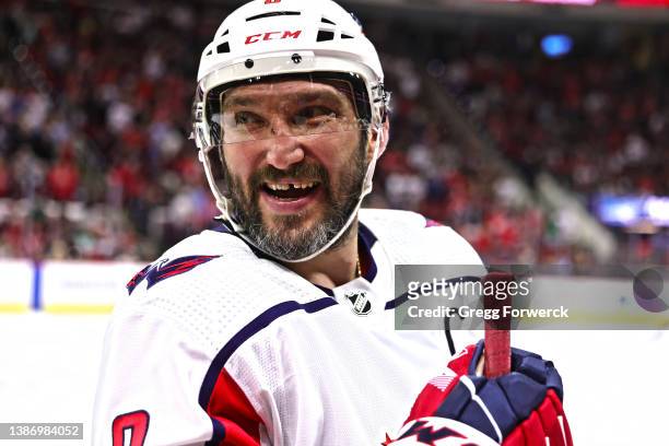 Alex Ovechkin of the Washington Capitals reacts to conversation during a timeout of an NHL game against the Carolina Hurricanes on March 18, 2022 at...