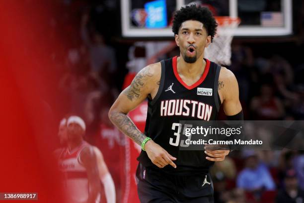 Christian Wood of the Houston Rockets reacts to hitting a three point basket during the second half against the Washington Wizards at Toyota Center...