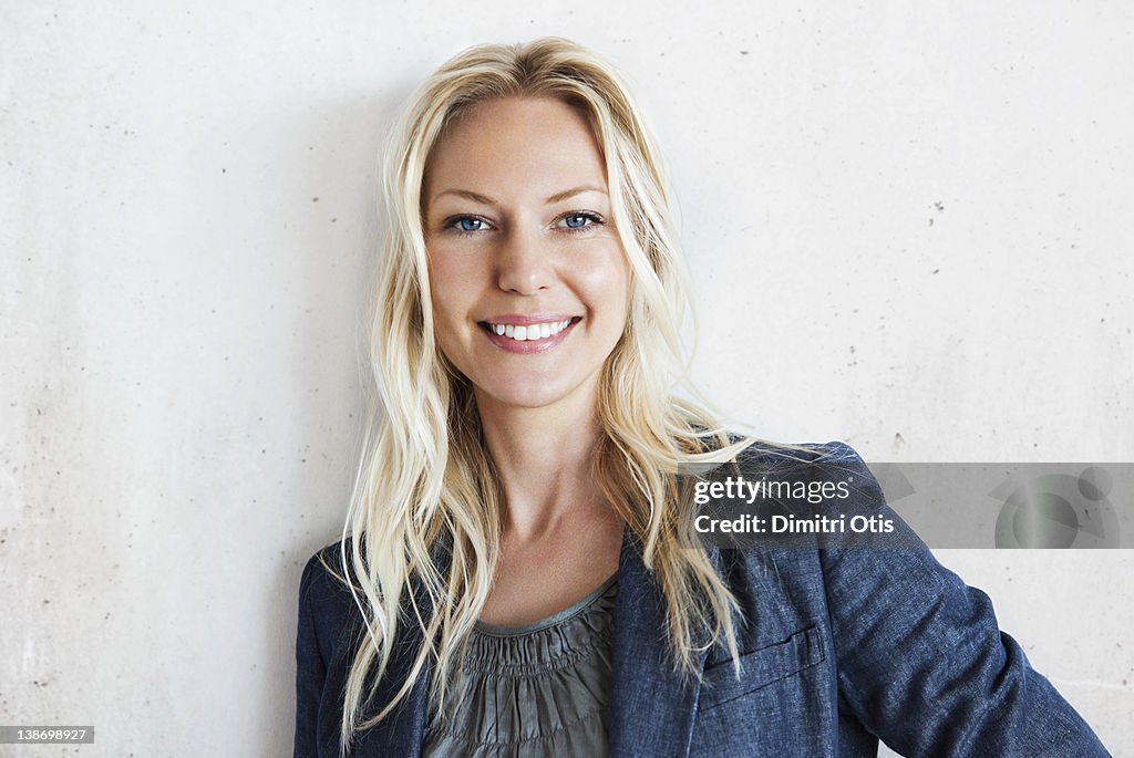 Portrait of blonde, relaxed businesswoman, smiling