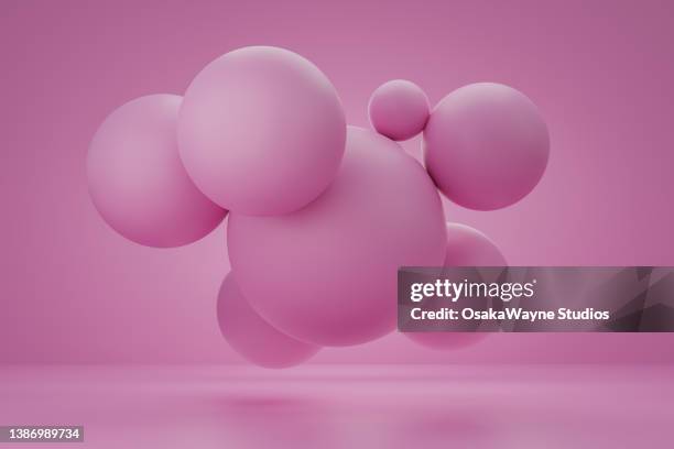 group of round pink balls against pink background - matte finish stock pictures, royalty-free photos & images