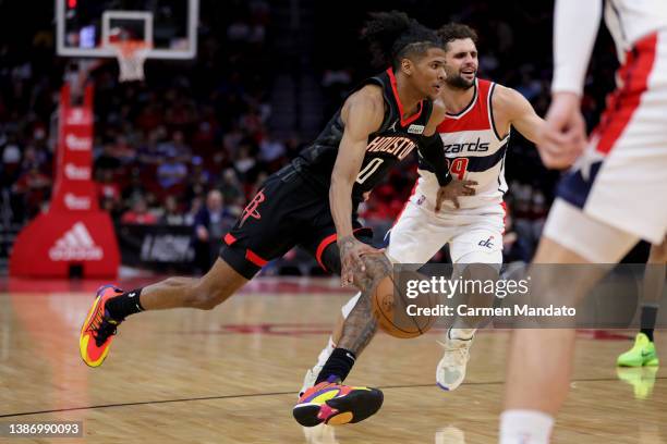 Jalen Green of the Houston Rockets controls the ball around Raul Neto of the Washington Wizards at Toyota Center on March 21, 2022 in Houston, Texas....