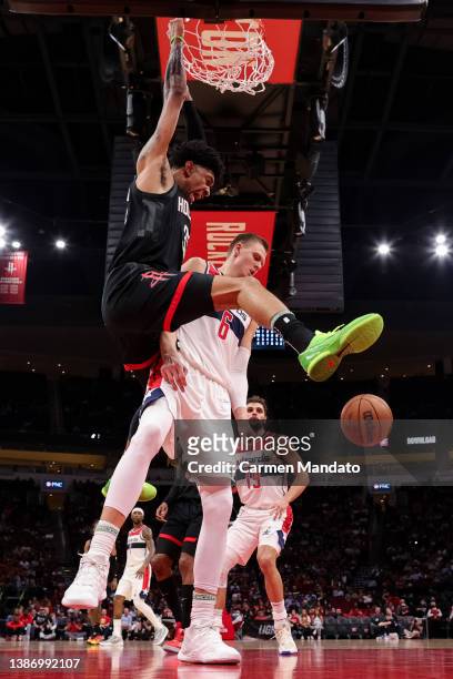 Christian Wood of the Houston Rockets dunks the ball over Kristaps Porzingis of the Washington Wizards during the first half at Toyota Center on...
