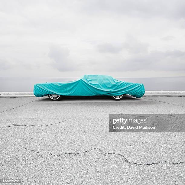 parked car with car cover. - car parked stock-fotos und bilder