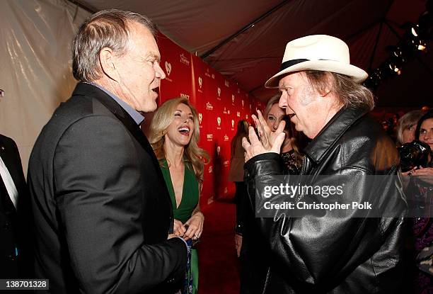 Musicians Glen Campbell and Neil Young arrive at The 2012 MusiCares Person of The Year Gala Honoring Paul McCartney at Los Angeles Convention Center...