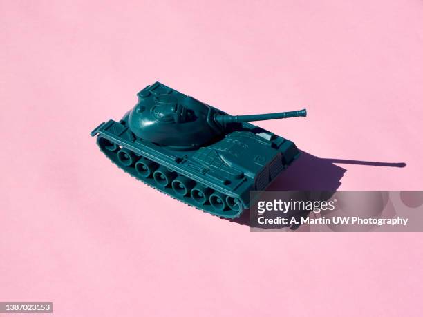 plastic toy tank isolated on pink background. - tank fotografías e imágenes de stock