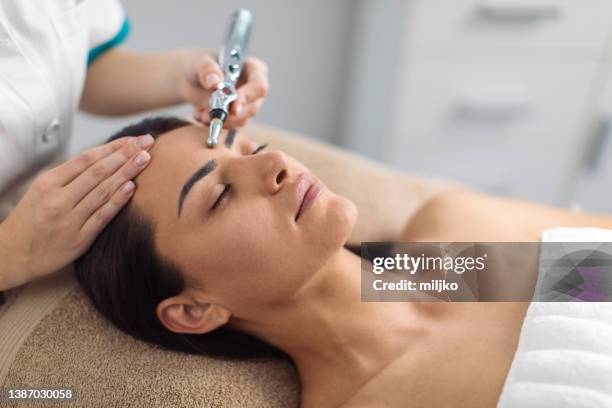 beauty treatment at professional dermatology clinic - laser face stock pictures, royalty-free photos & images