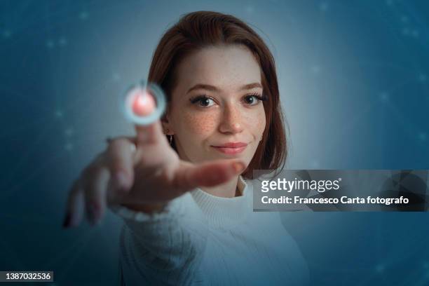 young woman touching power button - tocar fotografías e imágenes de stock