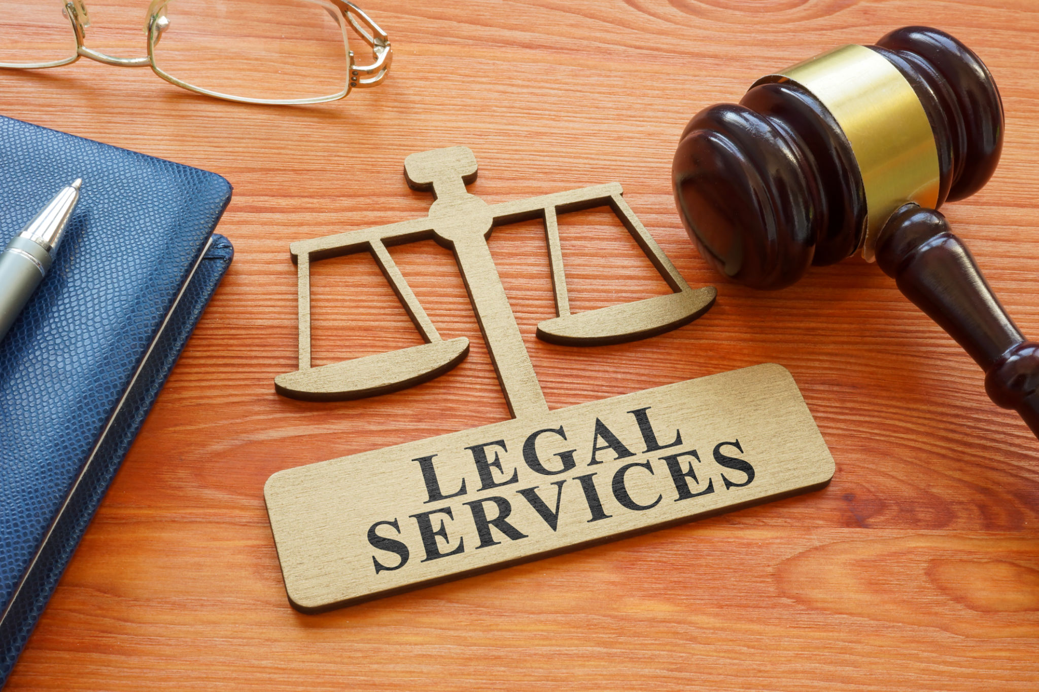 Gavel and scale model with inscription legal services. Gavel and scale model with inscription legal services.