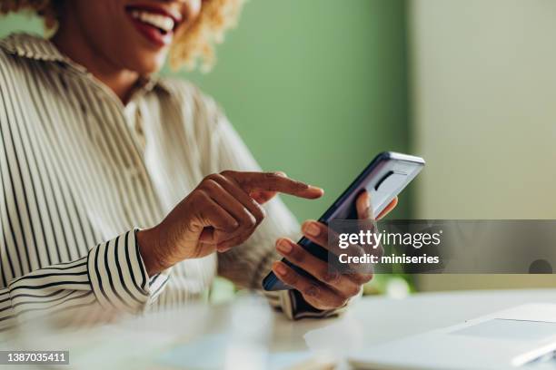 close up photo of woman hands using mobile phone in the office - talking close up business stockfoto's en -beelden