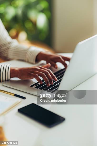 close up photo of woman hands using laptop computer in the office - tekst stockfoto's en -beelden