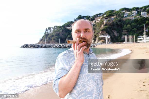 man smoking cigar at beach - 2022 a funny thing stock pictures, royalty-free photos & images