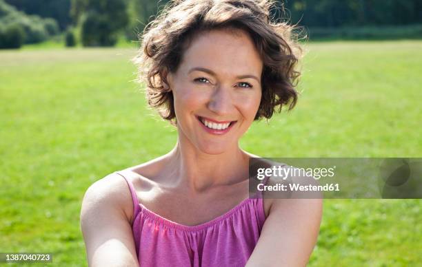 happy woman in casuals at park - women short hair stock pictures, royalty-free photos & images