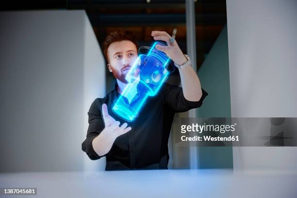 engineer analyzing cylinder in mid-air at control room - computer aided manufacturing stock pictures, royalty-free photos & images