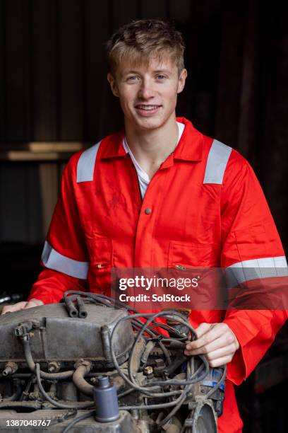 apprentice working on an engine repair - overalls stock pictures, royalty-free photos & images