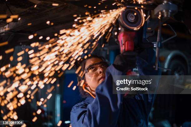 sparks coming from a grinder - slijptol stockfoto's en -beelden