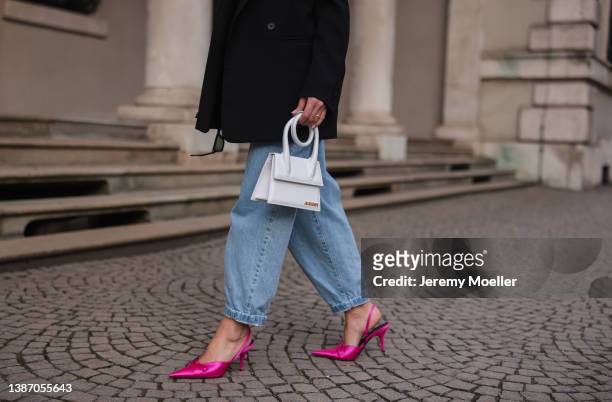Füsun Lindner seen wearing a black oversized blazer from Cos, a blue mom denim jeans from My Best Friends, pink Balenciaga high heels and a white...
