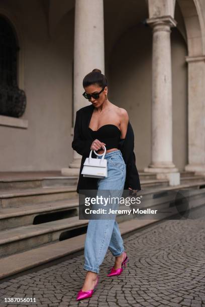 Füsun Lindner seen wearing a black Celine sunglasses, gold earrings from Louis Vuitton, a black oversized blazer from Cos, black crop top from My...