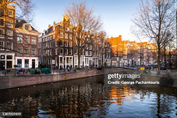 amsterdam canal houses during last sunlight - amsterdam winter stock pictures, royalty-free photos & images