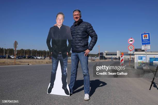 Tesla fan holds an effigy of Tesla CEO Elon Musk outside the new Tesla electric car manufacturing plant on the day of the plant's official opening on...