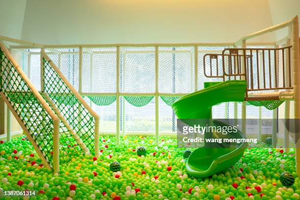 green ocean balls in the indoor children's play area - spring fete stock pictures, royalty-free photos & images