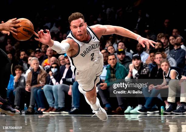 Blake Griffin of the Brooklyn Nets dives for a loose ball against Donovan Mitchell of the Utah Jazz during their game at Barclays Center on March 21,...