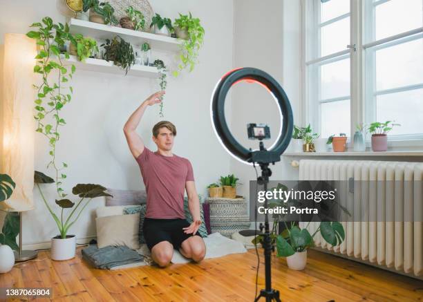man teaching yoga on live streaming at home - teacher zoom stock pictures, royalty-free photos & images