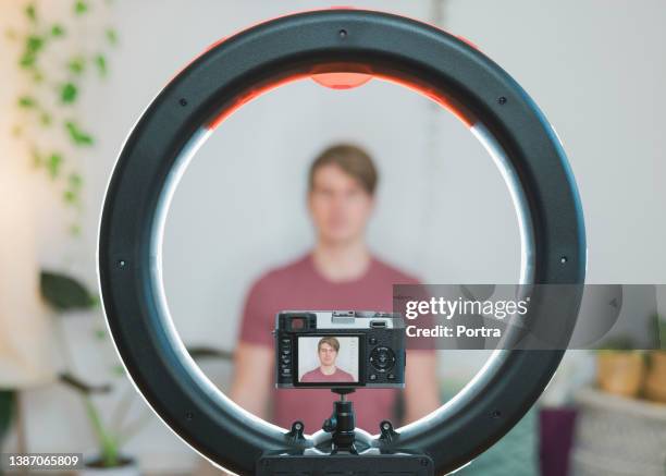 yoga teacher shoots video for blog with camera and ring light at home - one mid adult man only stock pictures, royalty-free photos & images