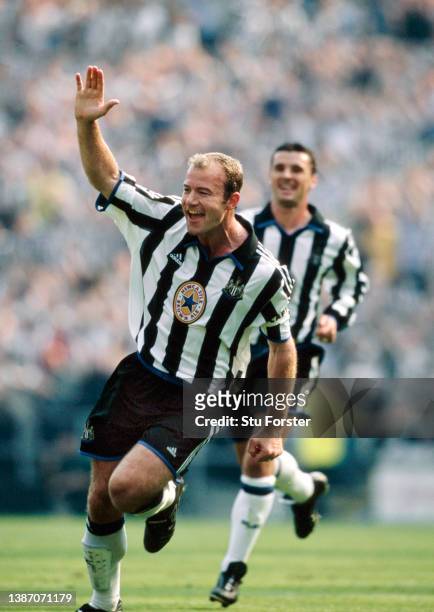 Newcastle United striker Alan Shearer celebrates after scoring the second Newcastle goal with his trademark one arm celebration as Gary Speed looks...