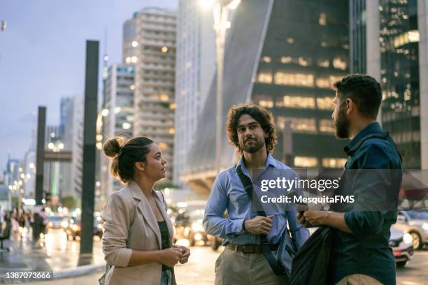 coworkers talking outdoors in the city - paulista avenue sao paulo stock pictures, royalty-free photos & images