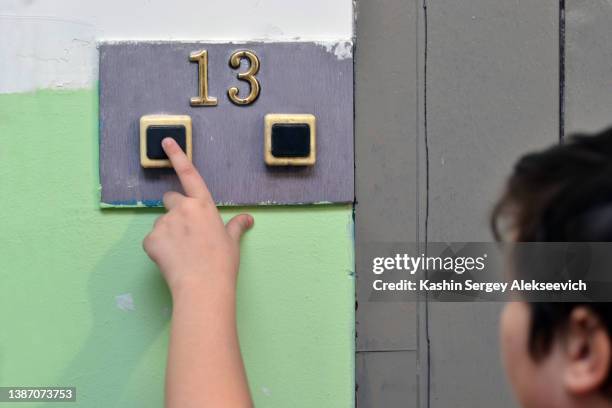 a young boy pushing doorbell. - doorbell stock pictures, royalty-free photos & images