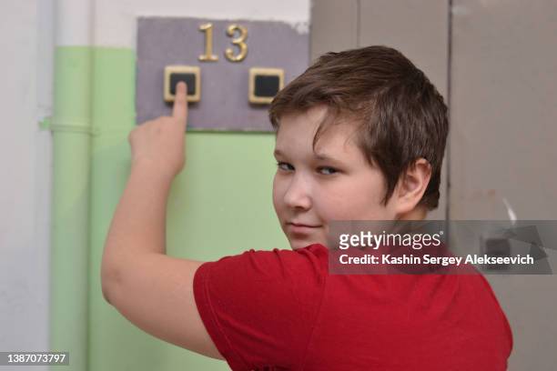 a young boy pushing doorbell. - doorbell stock pictures, royalty-free photos & images