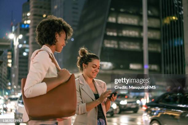 women talking outdoors in the city - avenue stock pictures, royalty-free photos & images