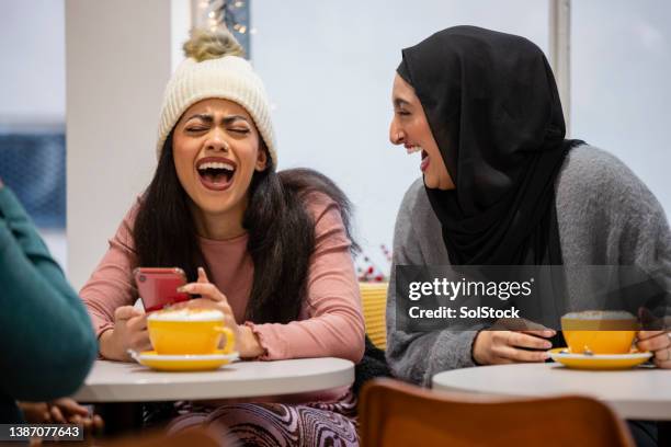 friends having a laugh in a coffee shop - muslim student stock pictures, royalty-free photos & images