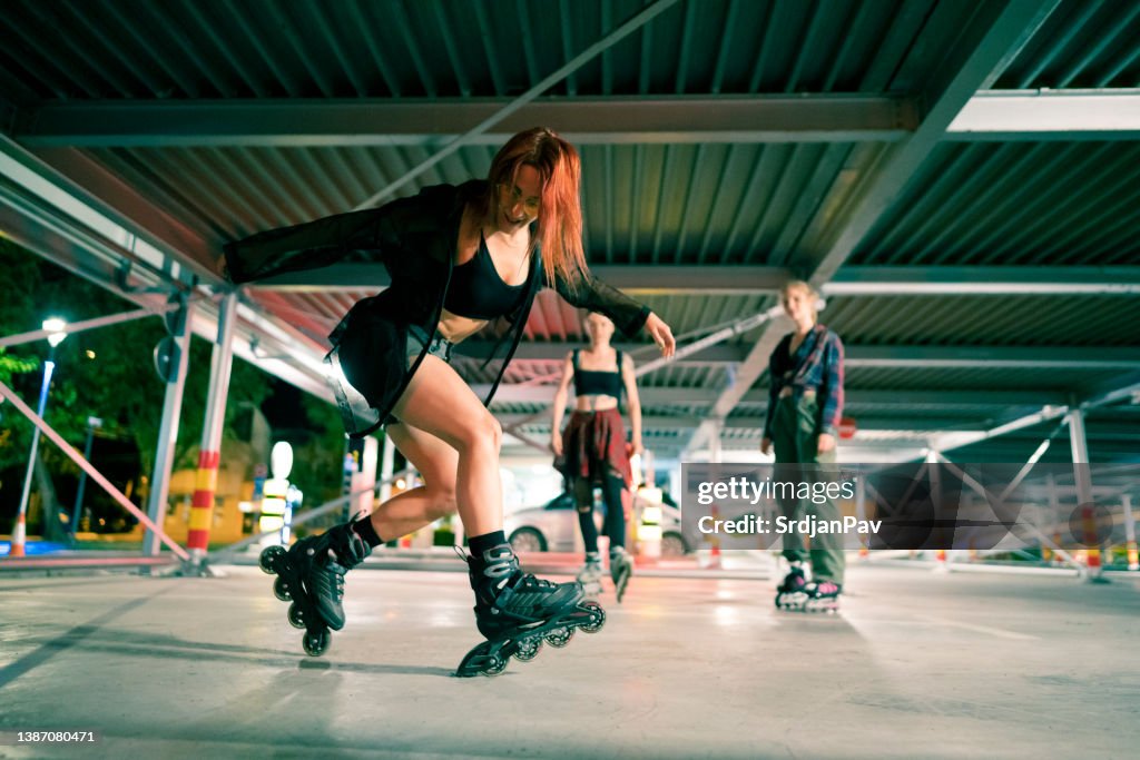 Young female friends having fun roller-skating