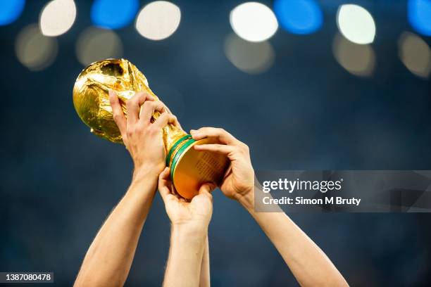 The World Cup Trophy is held a loft as the German team celebrates their victory. World Cup Final match between Germany and Argentina at the Maracana...