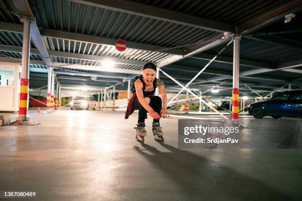 young female roller skater in a parking lot - inline skate bildbanksfoton och bilder