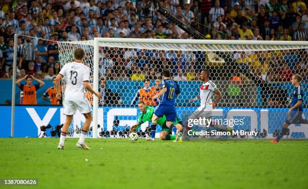 Manuel Neuer goalkeeper of Germany saves from Lionel Messi of Argentina during the World Cup Final match between Germany and Argentina at the...