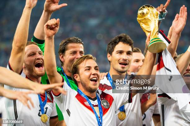Mario Goetze of Germany and goal scorer raises the World Cup trophy with teammates. World Cup Final match between Germany and Argentina at the...