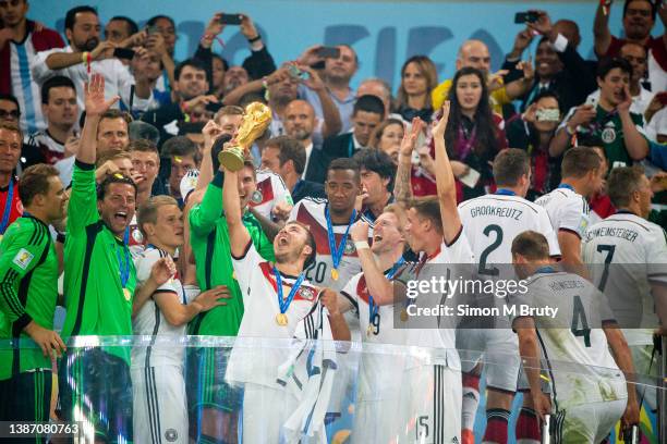 Mario Goetze of Germany and goal scorer raises the World Cup trophy with his teammates. World Cup Final match between Germany and Argentina at the...