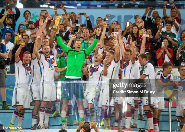 Manuel Neuer goal keeper of Germany raises the World Cup trophy with teammates, Christoph Kramer, Benedikt Hoewedes, Bastian Schweinsteiger, Lucas...