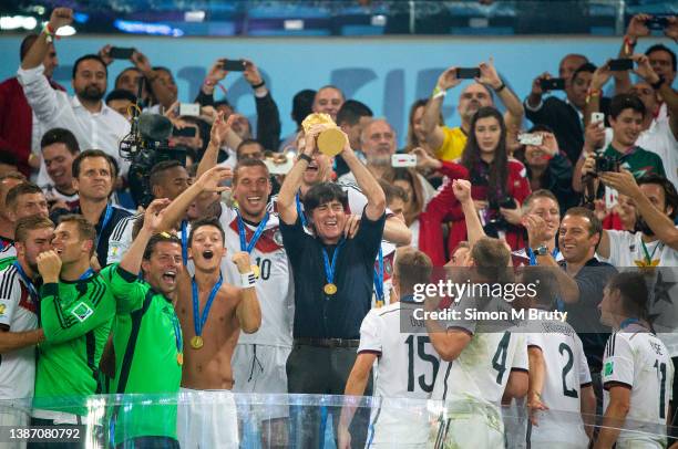 Joachim Low coach of Germany raises the World Cup trophy with, Lucas Podolski, Metzul Oezil and the rest of the team. World Cup Final match between...