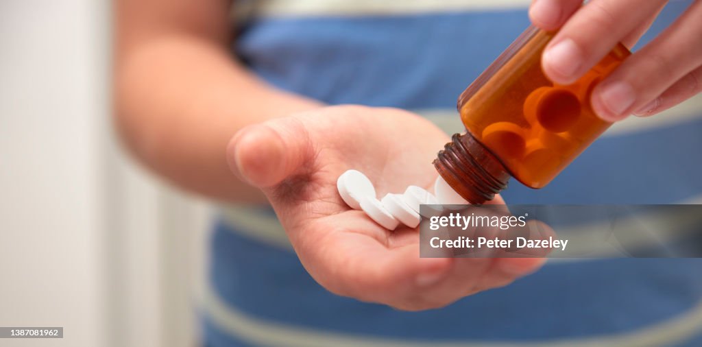 School boy taking pills