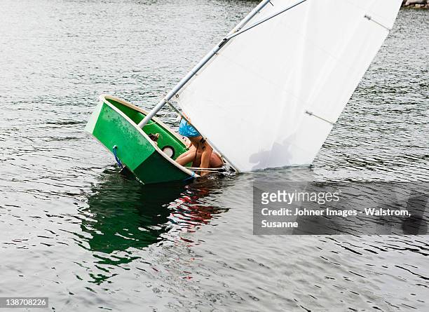 sailing dinghy falling into water - miss stock-fotos und bilder